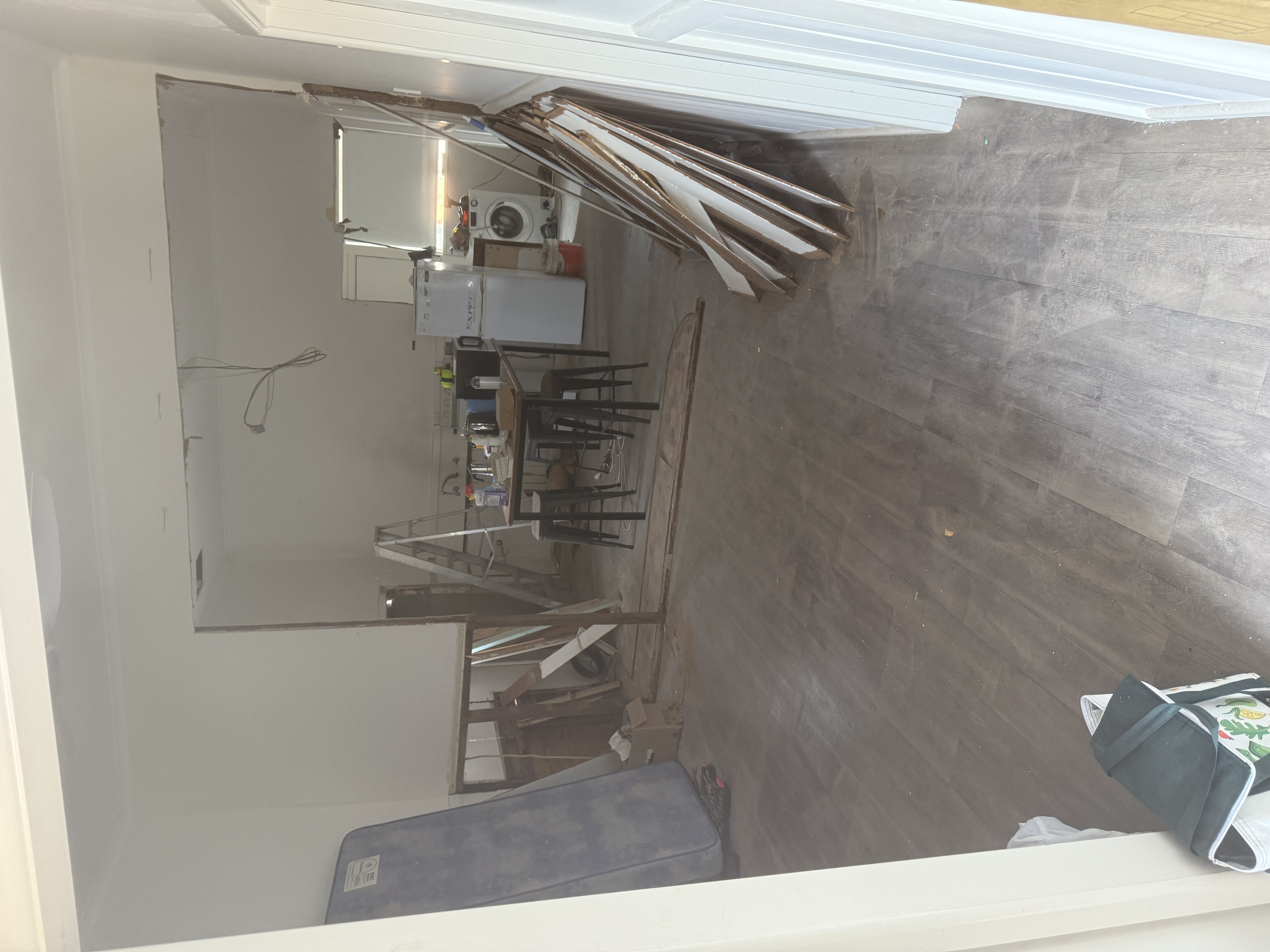 Interior before renovation — walls removed, flooring stripped
